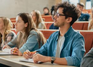 Students in a class attentively listening to the professor